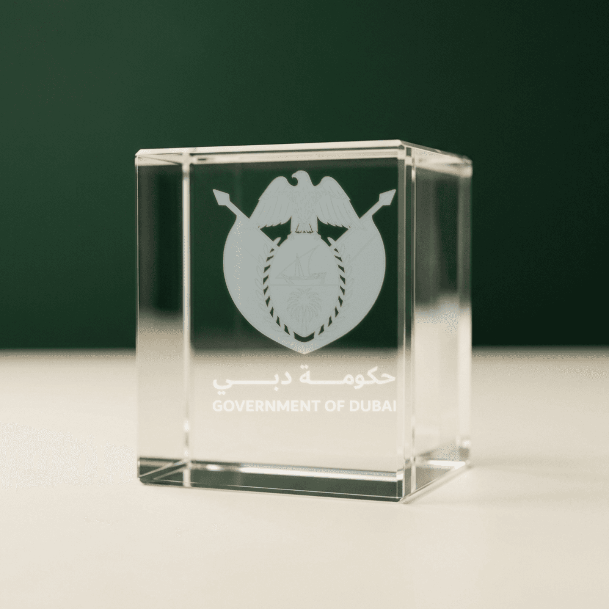 A single lit crystal award catching brass light on a dark ground